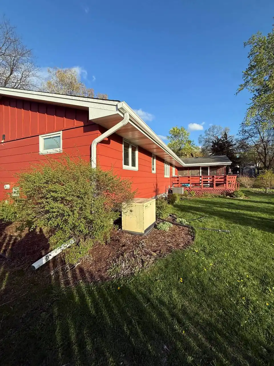 Long run of white seamless gutters on a ranch-style home in Eden Prairie with proper water diversion.
