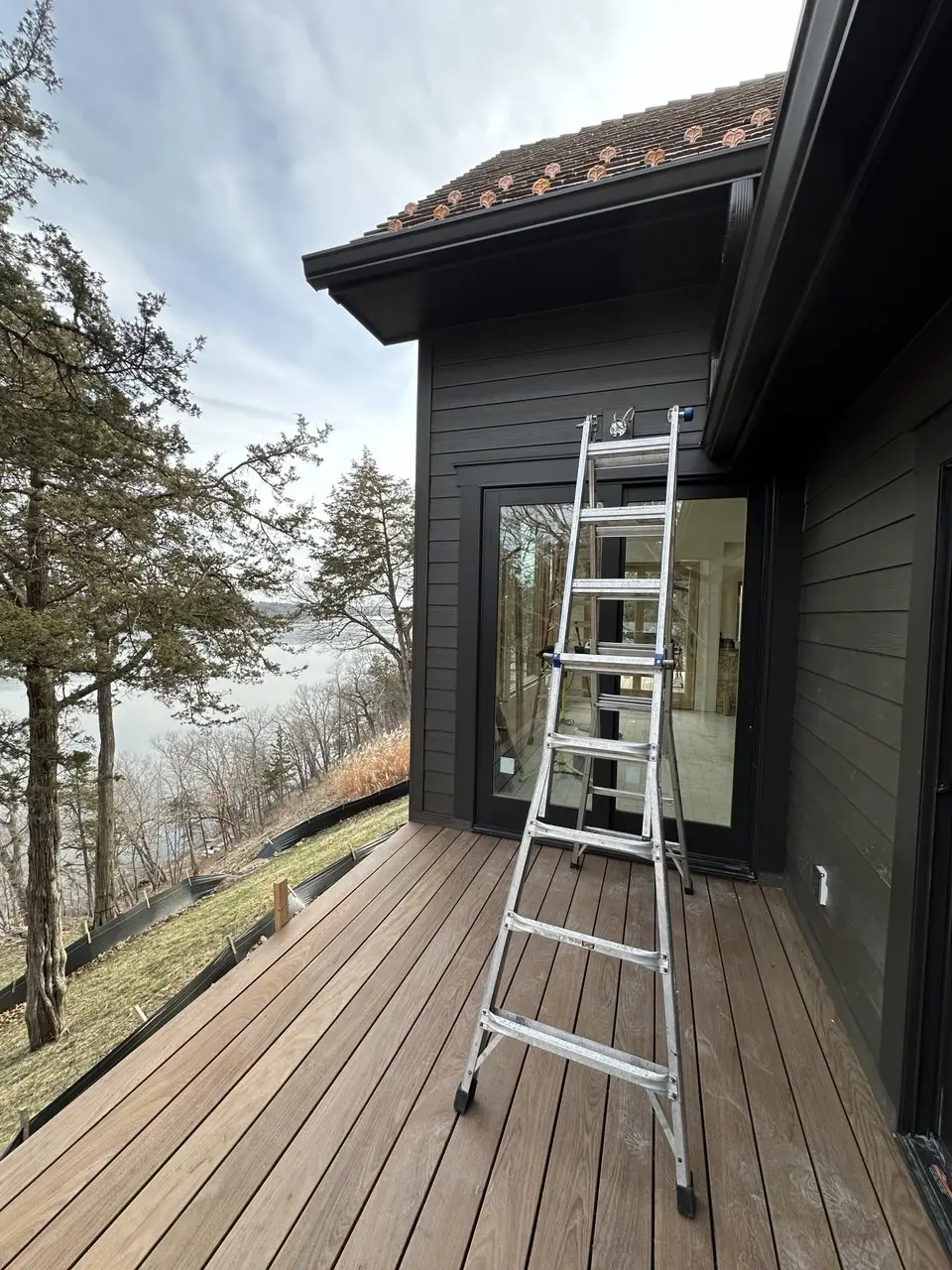 Professional gutter installation on a lakeside home in Woodbury MN area