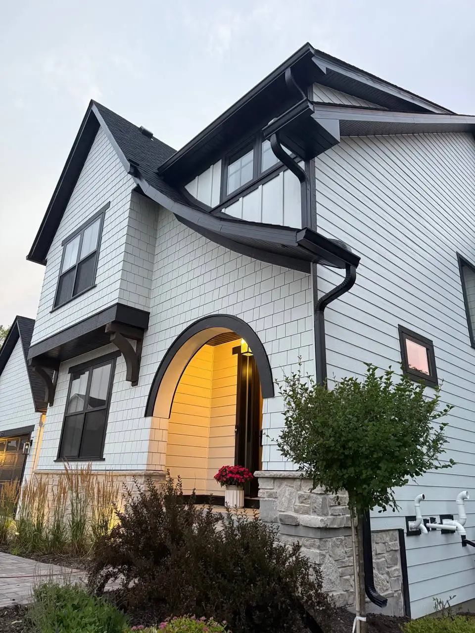 Custom dark gutter and downspout system on an elegant home in Minnetonka, MN