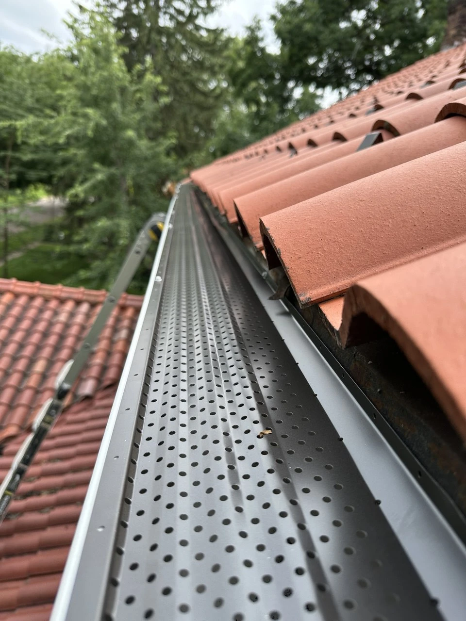 Gutter guard installation on clay tile roof in Wayzata, MN