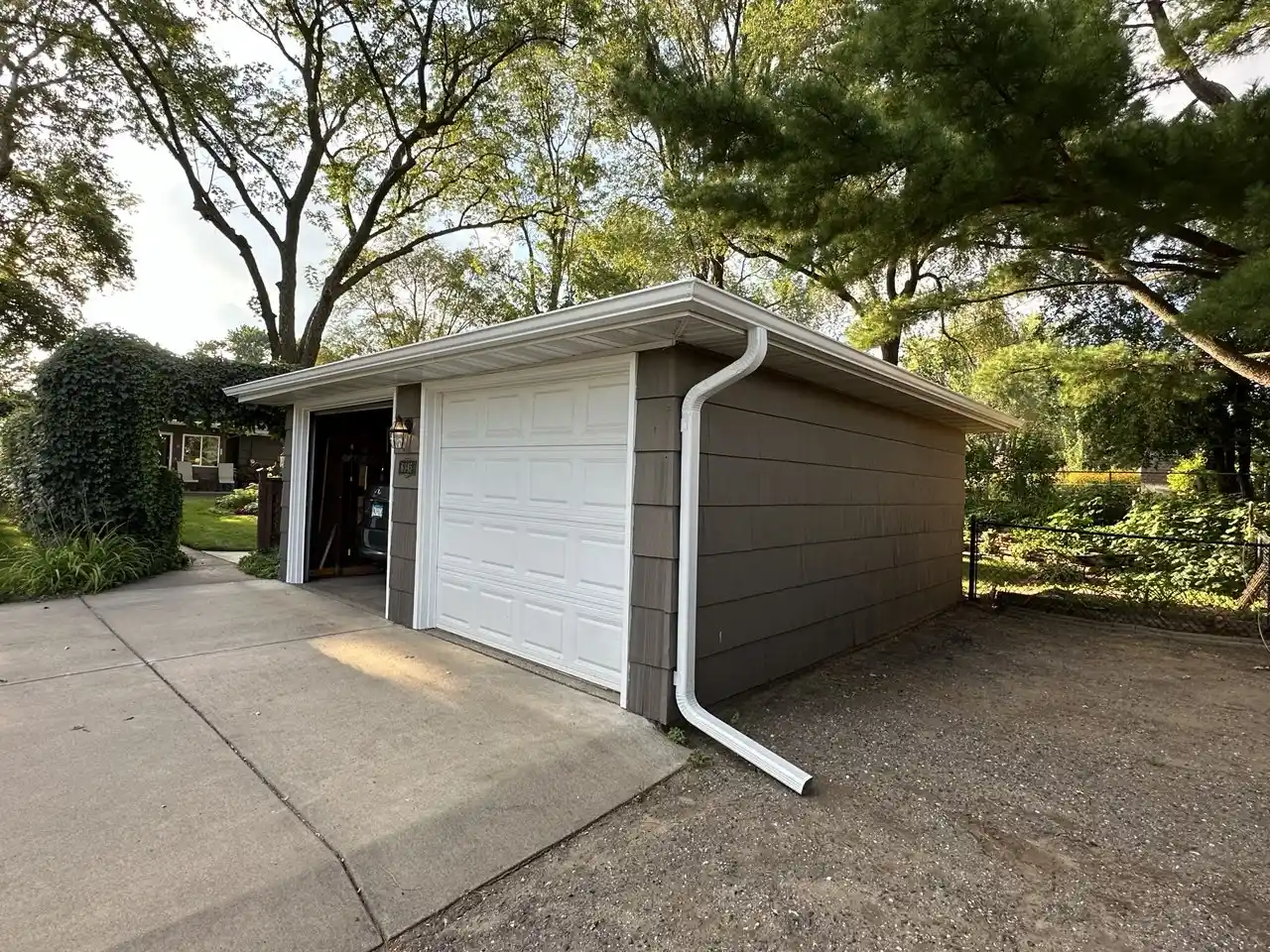 Professional downspout installation and routing on a residential property in Minnesota